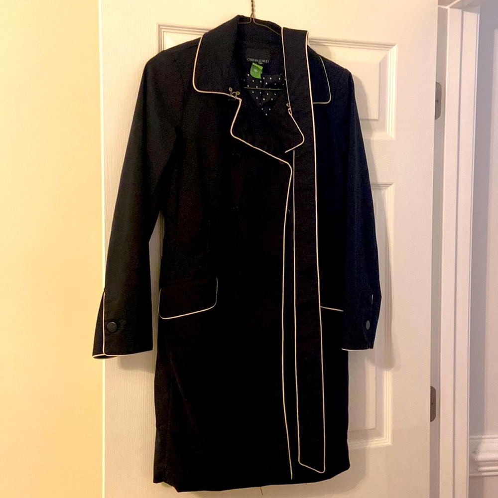 Pea coat style at top. Classic black with cream trim and polka dot lining.